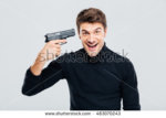 stock-photo-crazy-cheerful-young-man-put-gun-to-temple-and-laughing-483070243.jpg